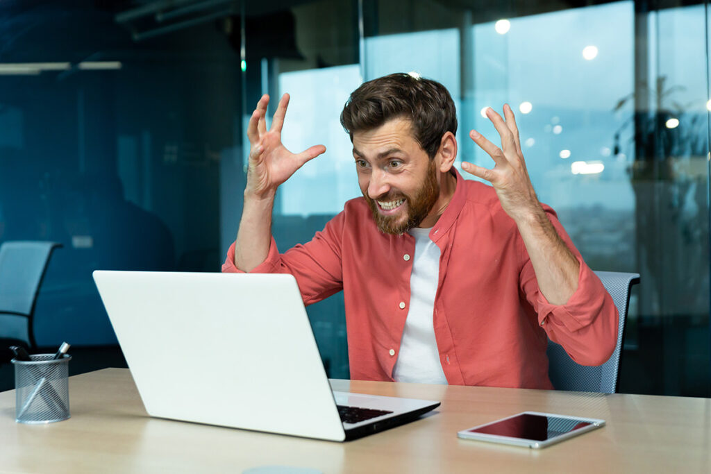angry and nervous businessman talking on video cal