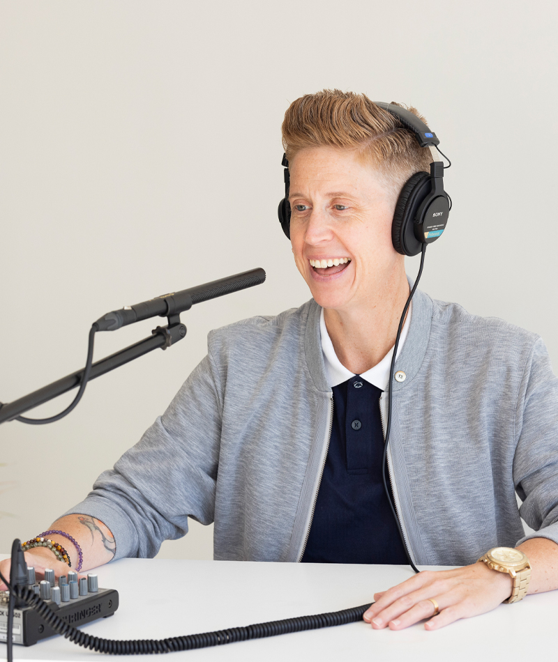 Heather Holloway performing voiceover work at a microphone.