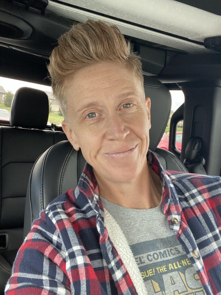 Heather Holloway sitting in a car smiling at the camera.